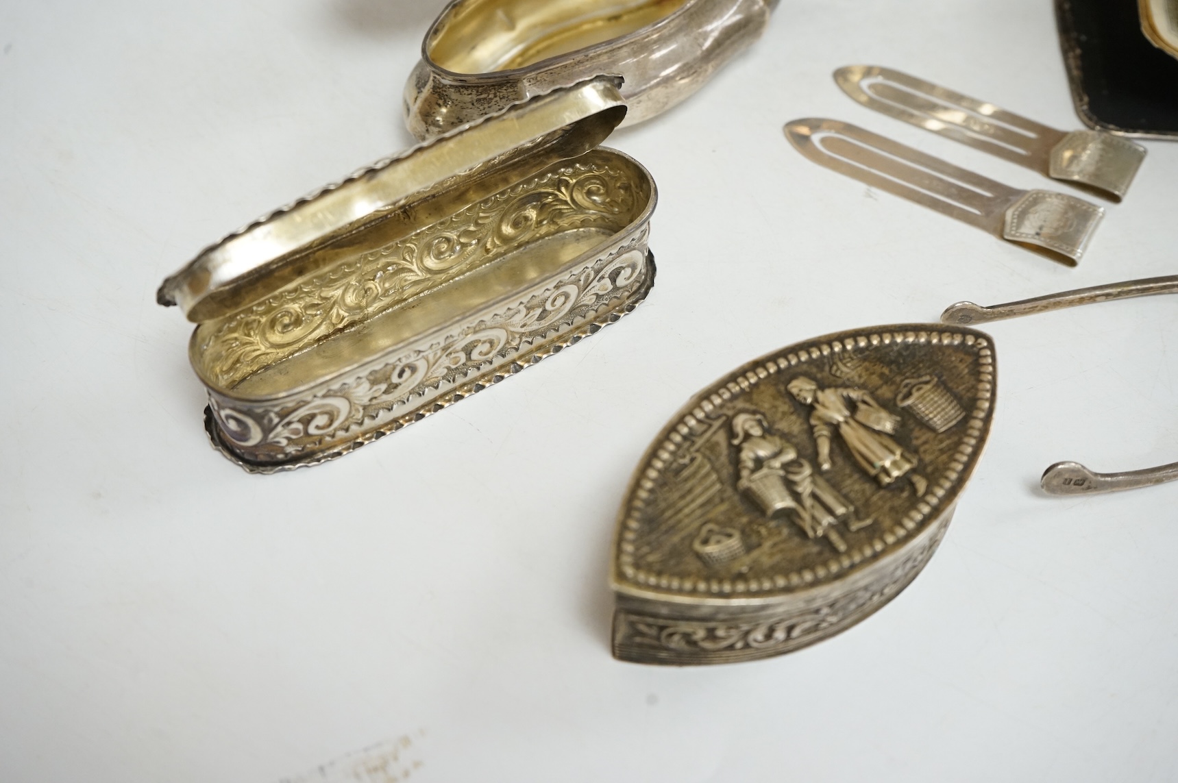 Three late 19th/early 20th century repousse silver trinket boxes, including one with Reynold's Angels decoration, Birmingham, 1899, 91mm, a larger 19th century Dutch white metal oval box and cover, a pair of wishbone sil